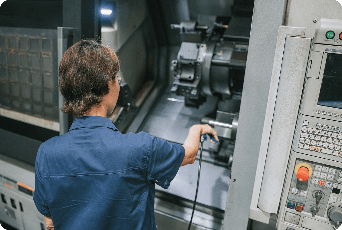 Machinist operating manufacturing equipment