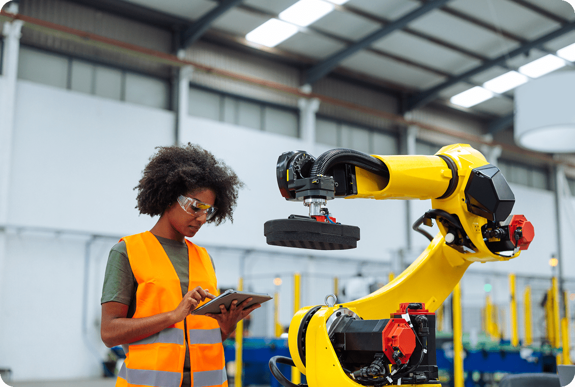 Factory worker using industrial robot